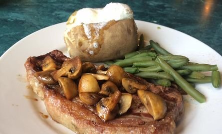 !2 oz NY Strip steak topped with teriyaki mushrooms, served with baked potato and veggies, WOW Diner